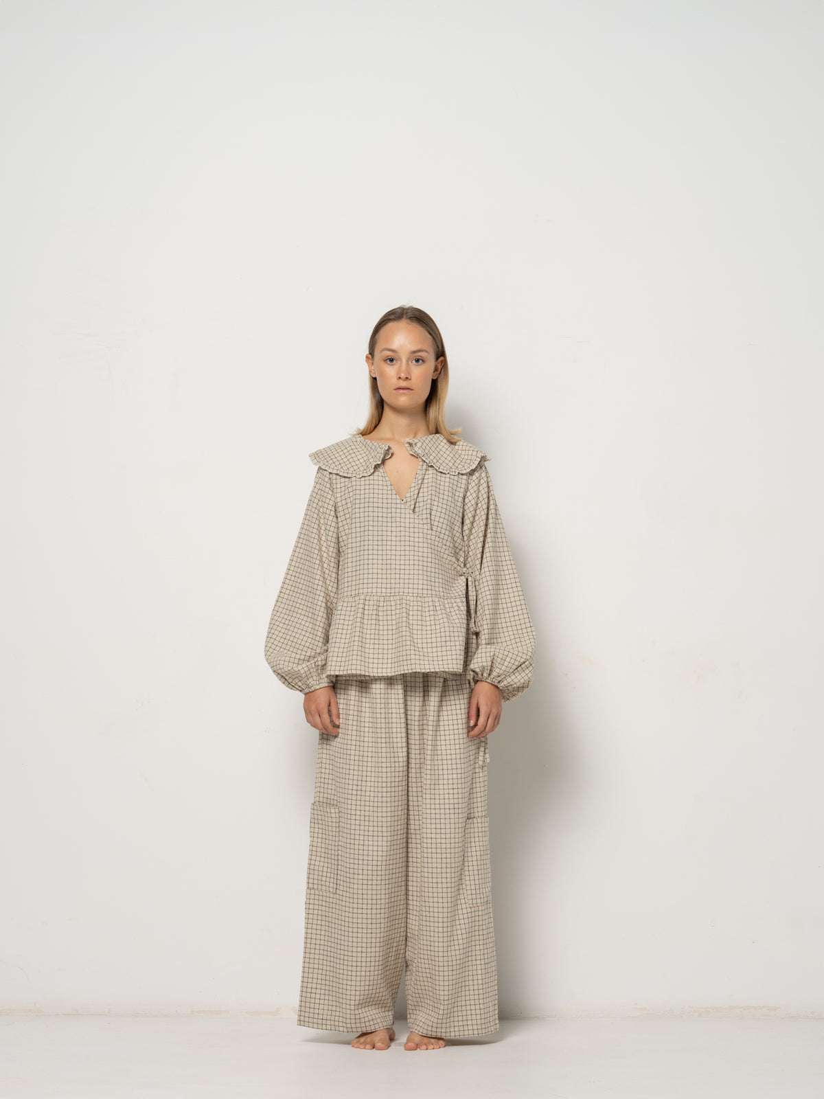 Ada Mini Collar Blouse, this collar checkered blouse features inside and outside straps, providing both elegance and functionality. Made from a blend of Hemp and Organic Cotton Yarn, it offers durability for an eco-friendly addition to your wardrobe.