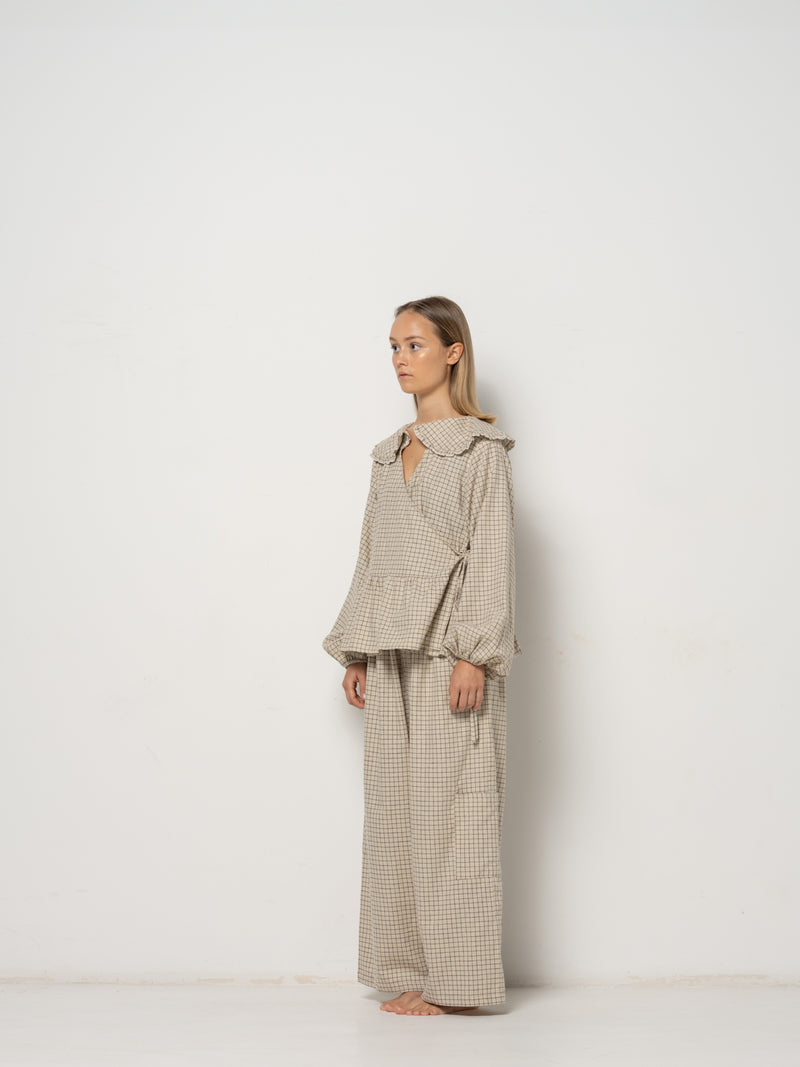 Ada Mini Collar Blouse, this collar checkered blouse features inside and outside straps, providing both elegance and functionality. Made from a blend of Hemp and Organic Cotton Yarn, it offers durability for an eco-friendly addition to your wardrobe.