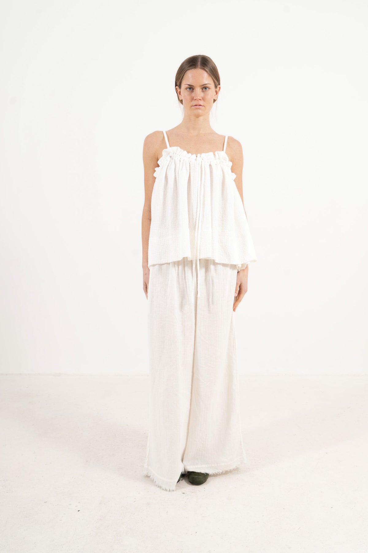 Front view studio portrait featuring a model in the solid Adeline top by MOCHA, capturing its quiet femininity and effortless elegance.