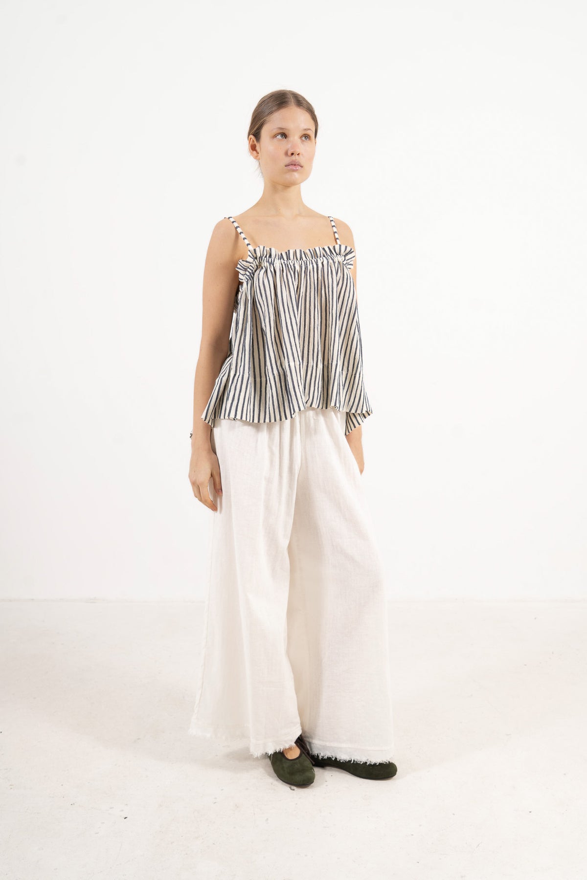 Profile studio portrait showcasing the versatile fit and delicate straps of the MOCHA Adeline top.