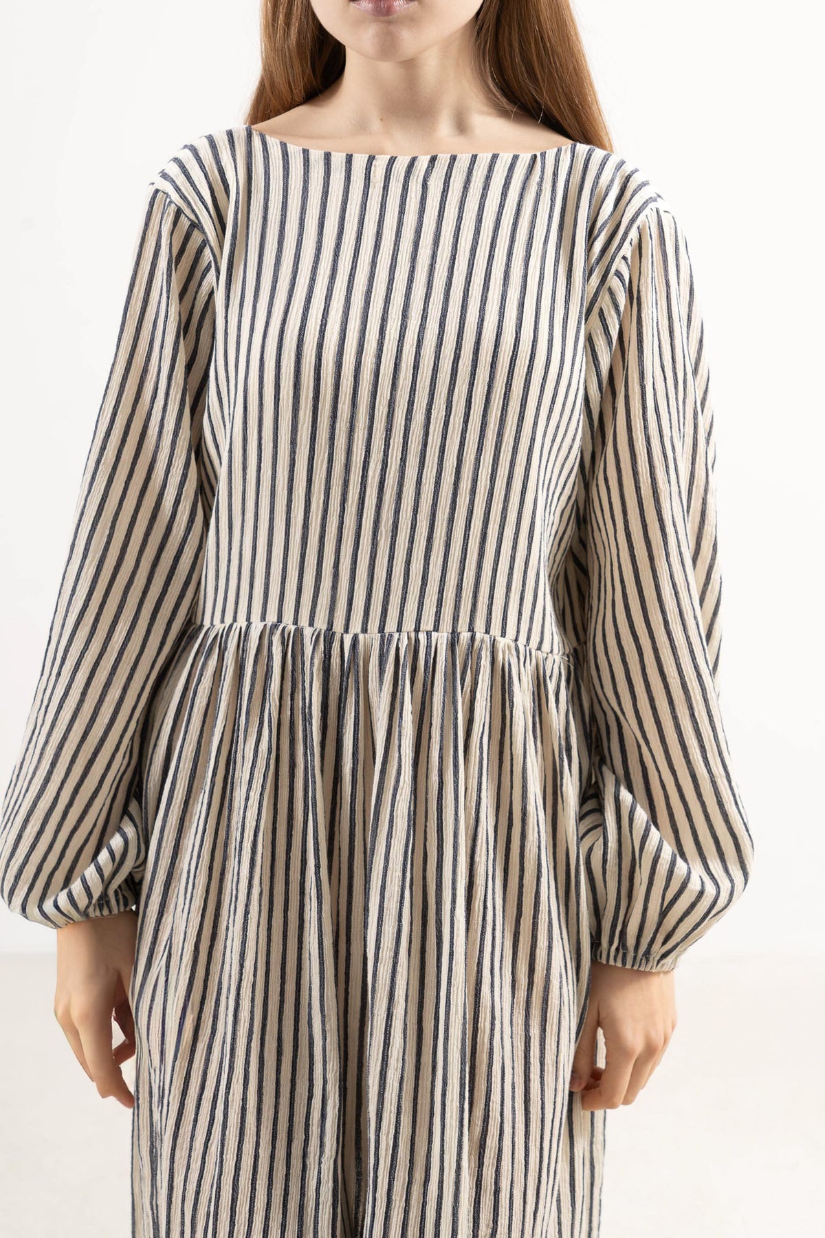 Close-up detail shot focusing on the delicate fine stripe texture and high-quality weave of the MOCHA organic cotton fabric