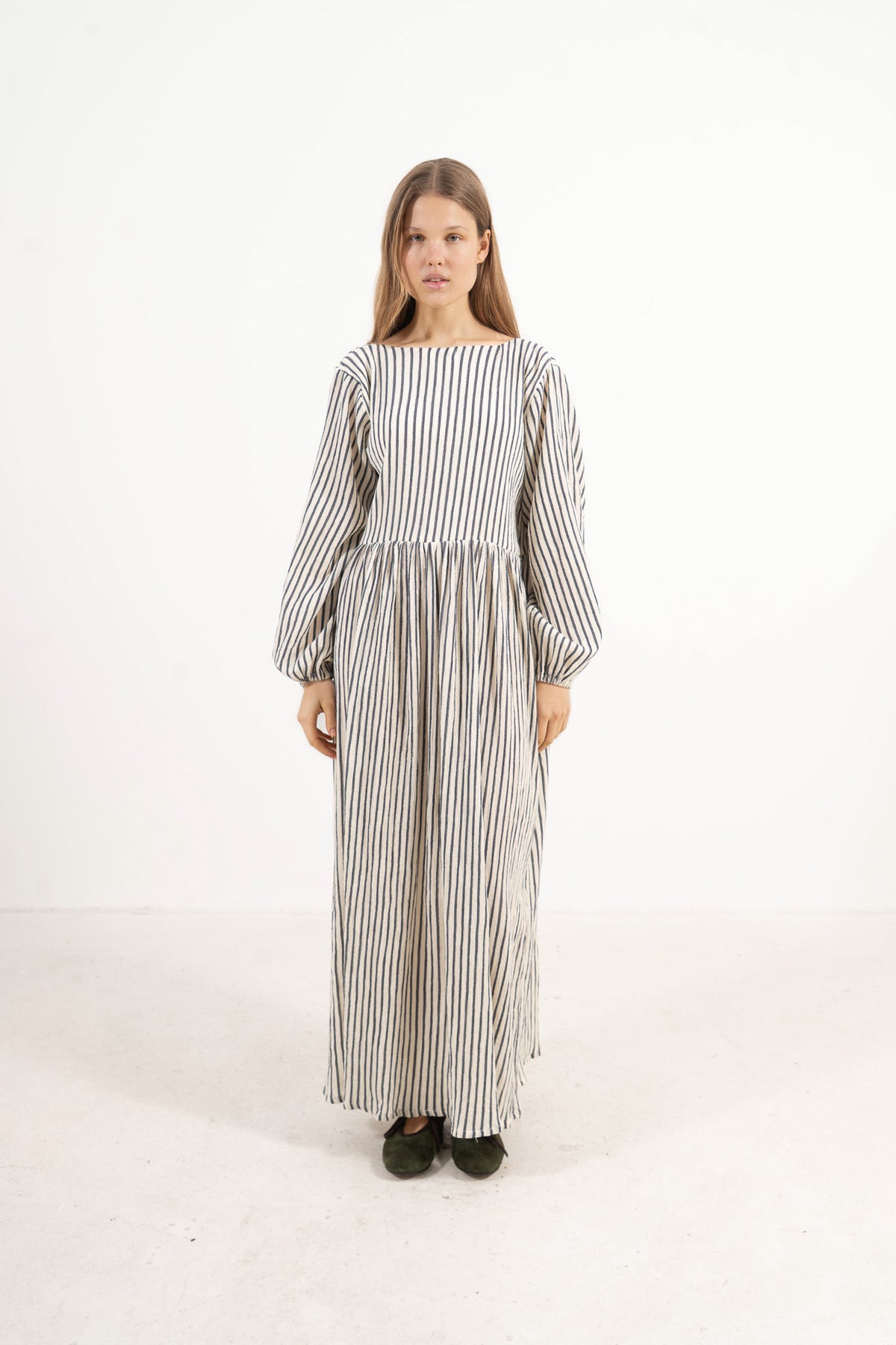 Front view studio portrait featuring a model in the striped Amadea long dress by MOCHA, capturing its effortless ease and airy elegance.