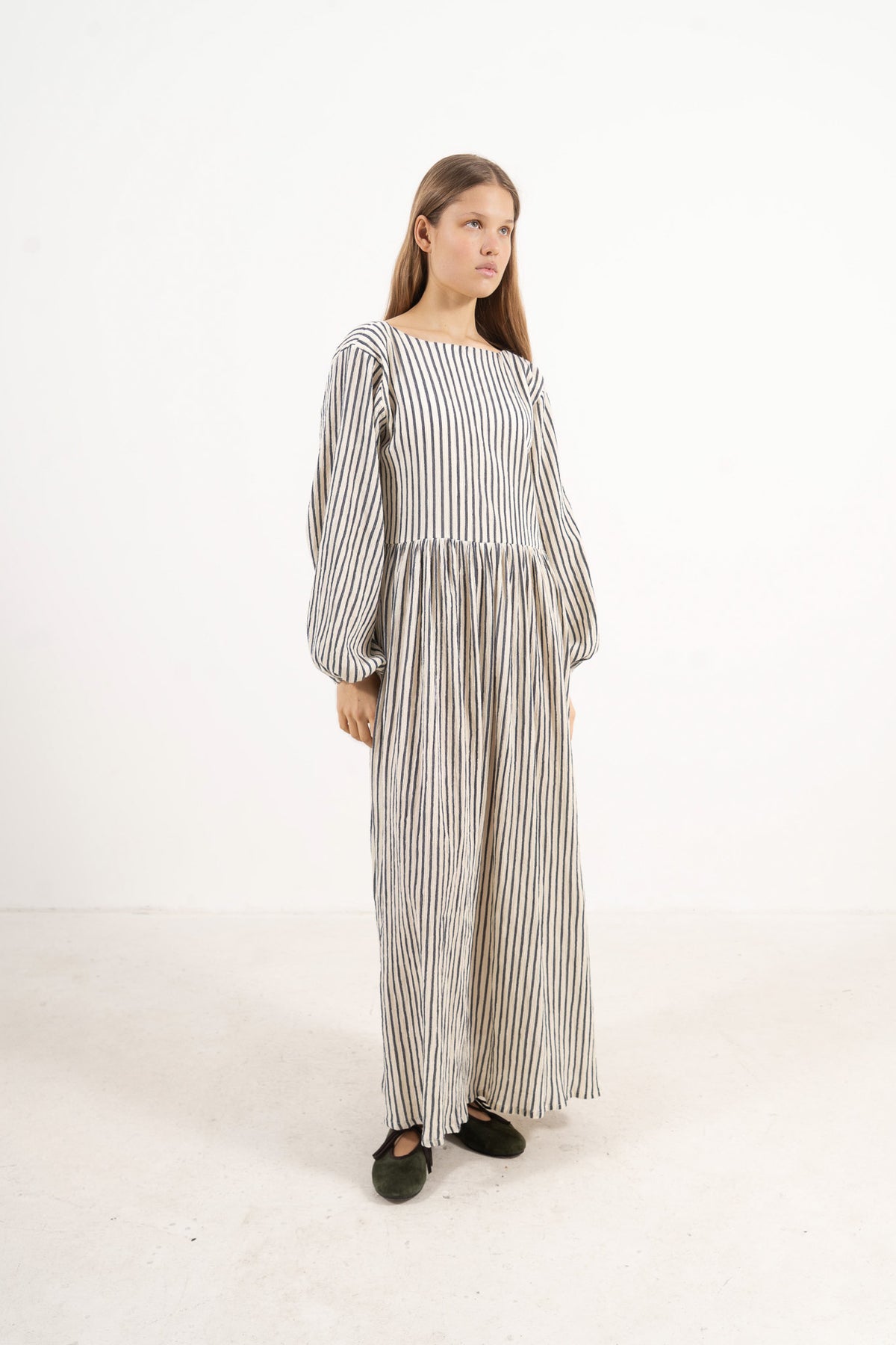 Side lookbook capture of the striped organic cotton dress, emphasizing the beautiful, effortless flow inspired by air and movement.
