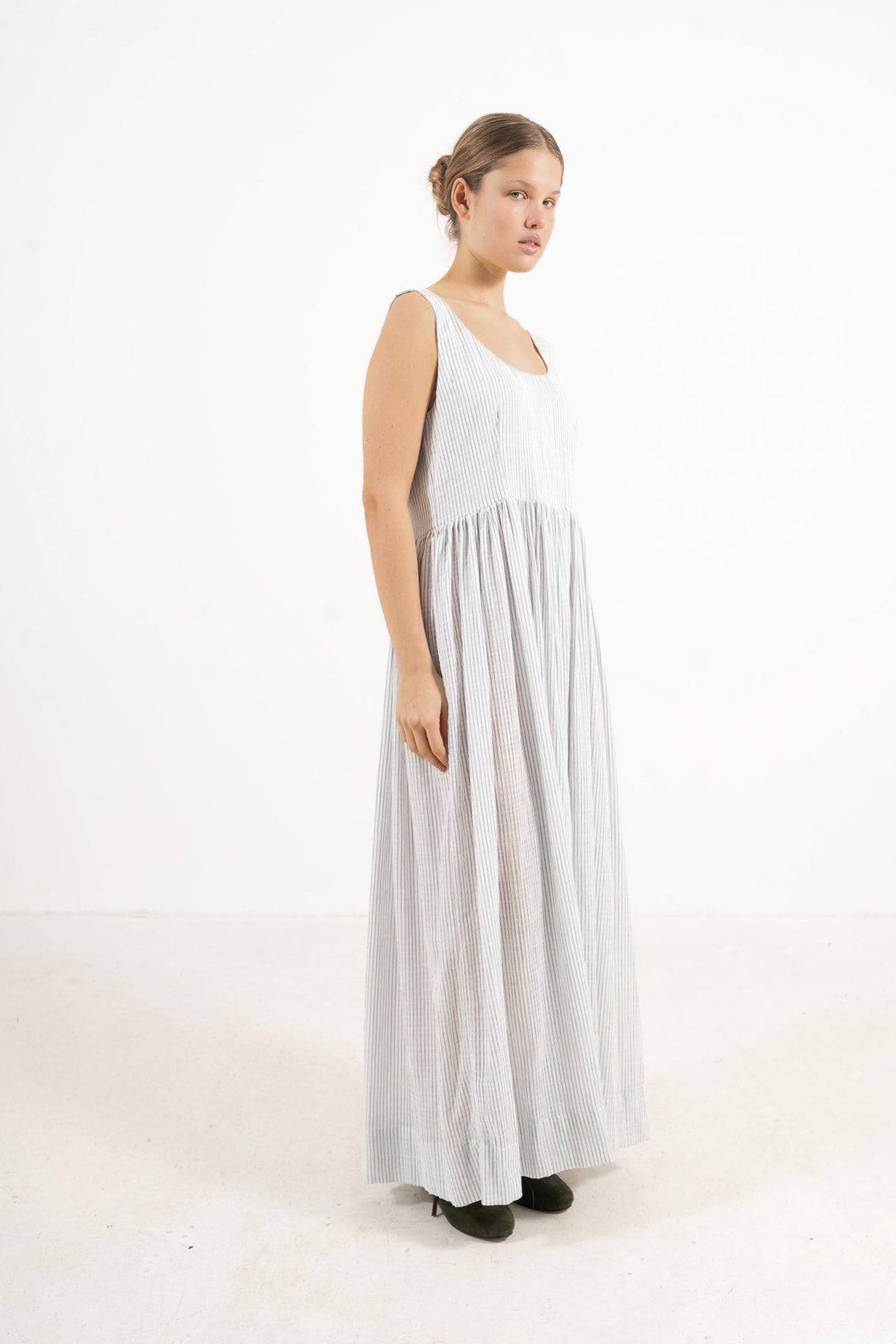  Side lookbook capture of the fine stripes organic cotton dress, emphasizing the beautiful, effortless flow inspired by air and movement.