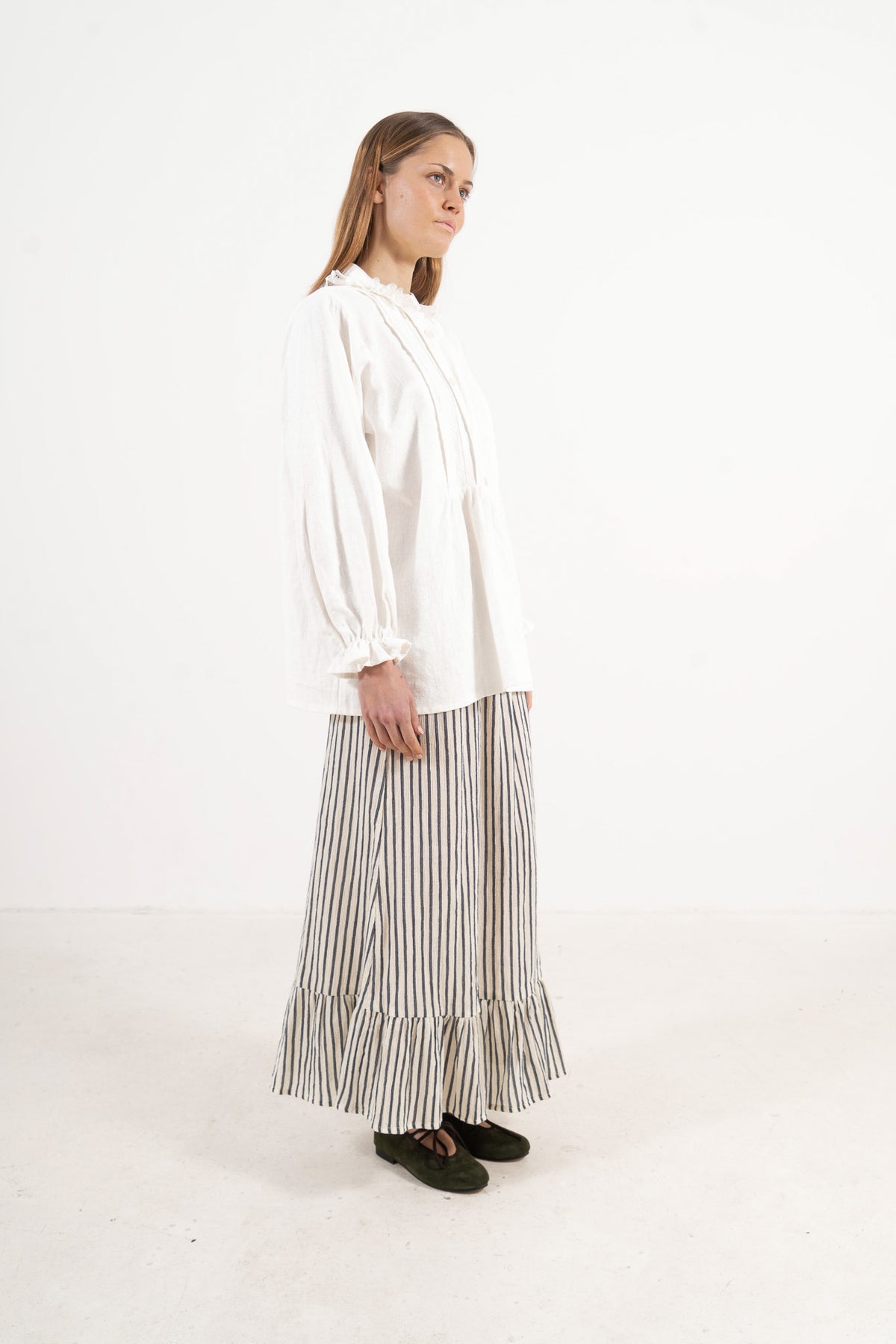 Side lookbook capture of the organic cotton blouse, emphasizing the beautiful movement of the long sleeves and flowing fabric.
