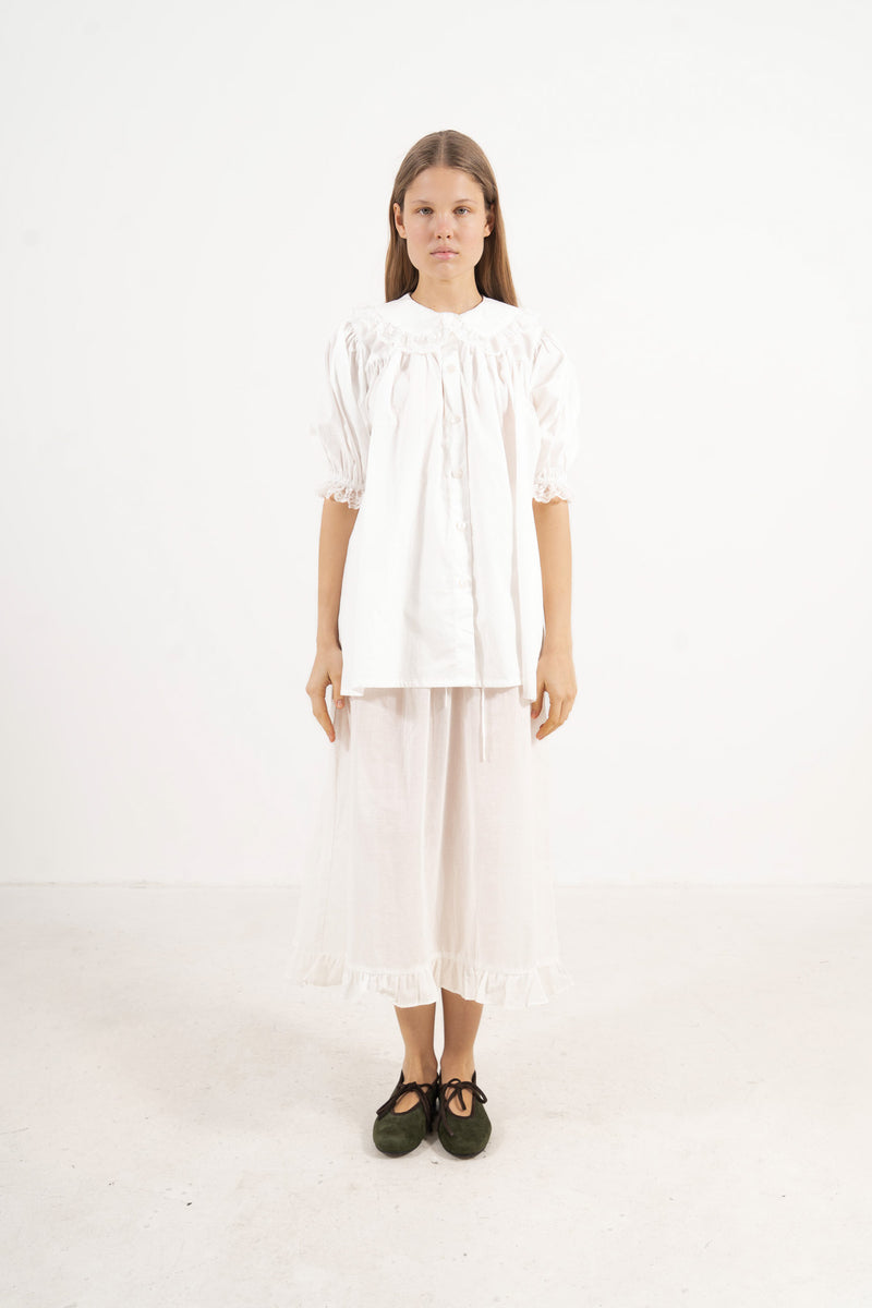 ront view studio portrait featuring a model in the Amour Blouse by MOCHA, wrapping you in effortless elegance and gentle lightness.