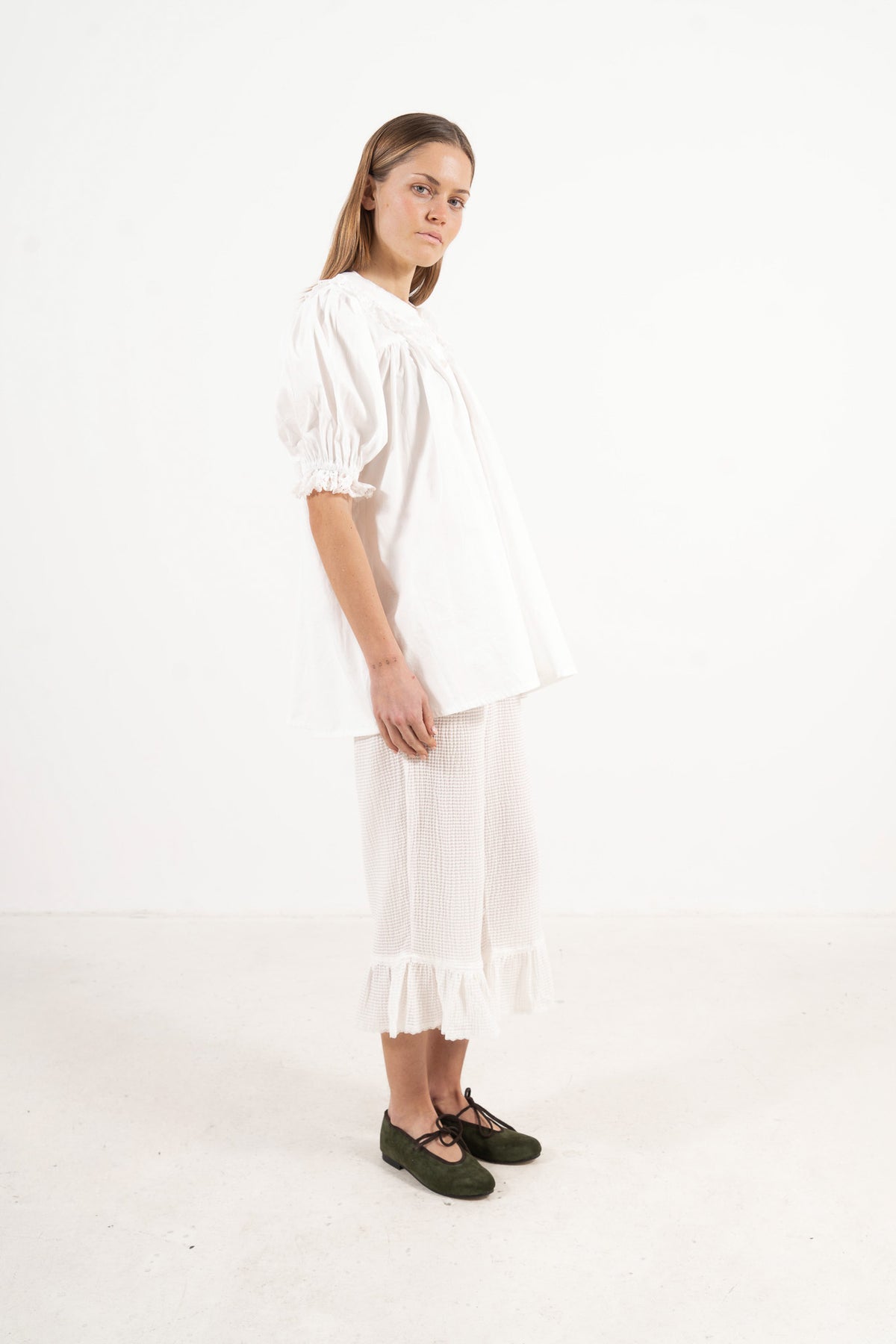 Side lookbook capture of the organic cotton blouse, emphasizing the beautiful movement of the long sleeves and flowing fabric.