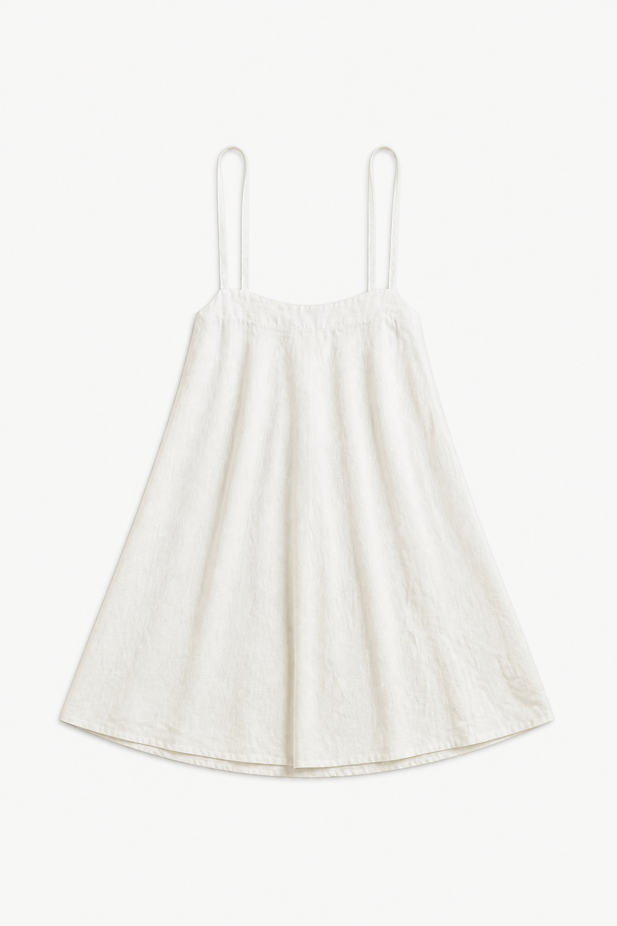Minimalist flat lay of the MOCHA Apron Skirt, highlighting the airy, soft organic cotton texture and its pure, clean silhouette.