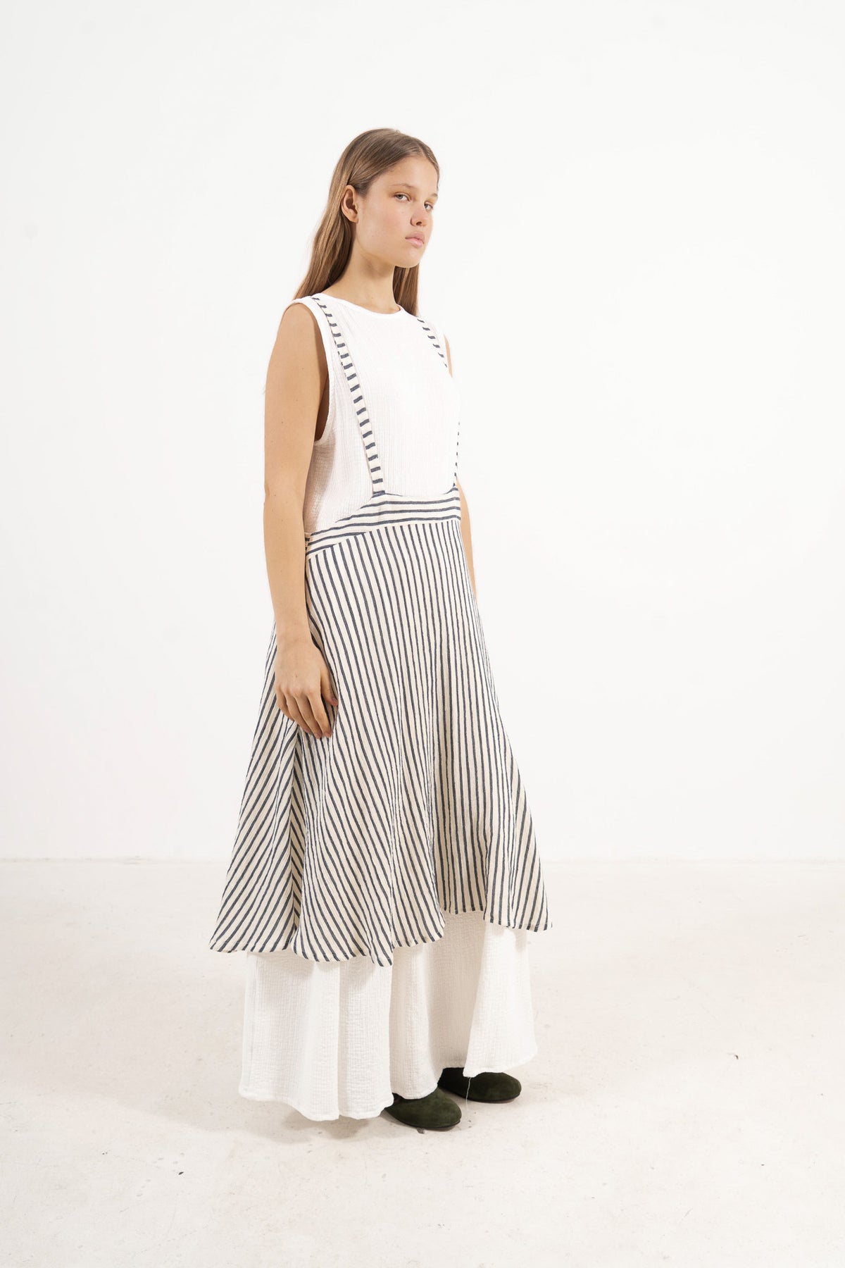 Side profile view of the MOCHA apron skirt showing its depth, strap placement, and long flowing silhouette.