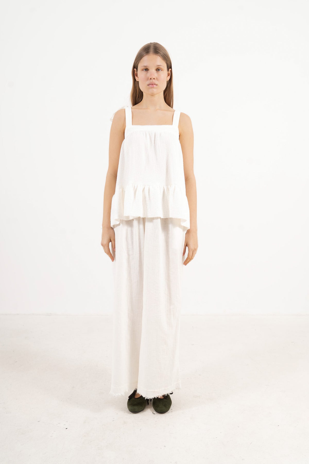 Front view studio portrait featuring a model in the white Belle top by MOCHA, capturing its subtle detailing and quiet femininity.