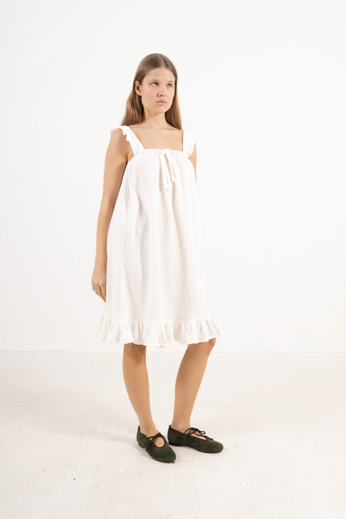 Side lookbook capture of the fine cotton dress, emphasizing the beautiful, lightweight drape inspired by air, movement, and gentle days.