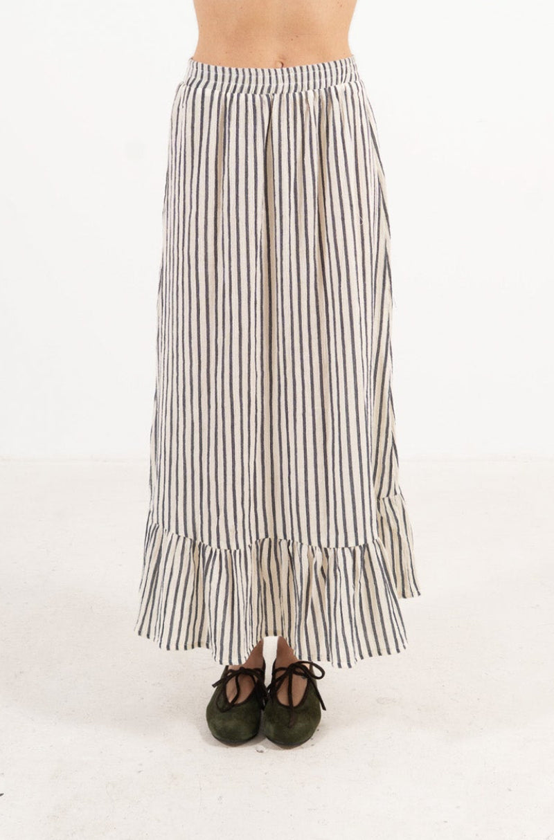Front view studio portrait featuring a model in the striped organic cotton Élodie skirt by MOCHA, capturing its effortless elegance and flowing, graceful length.