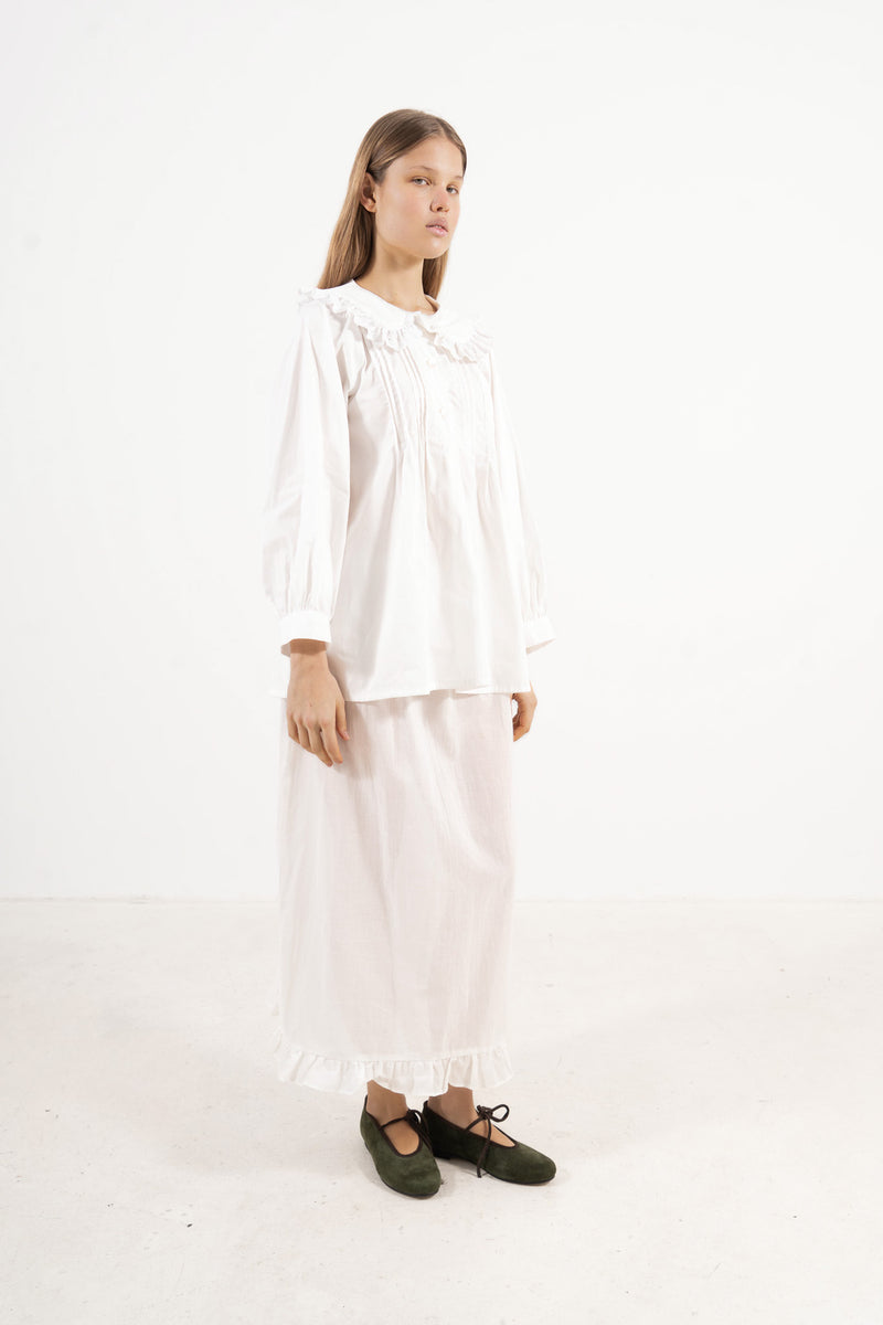 Side lookbook capture of the premium cotton blouse, emphasizing the beautiful movement of the long sleeves and flowing fabric inspired by gentle days.