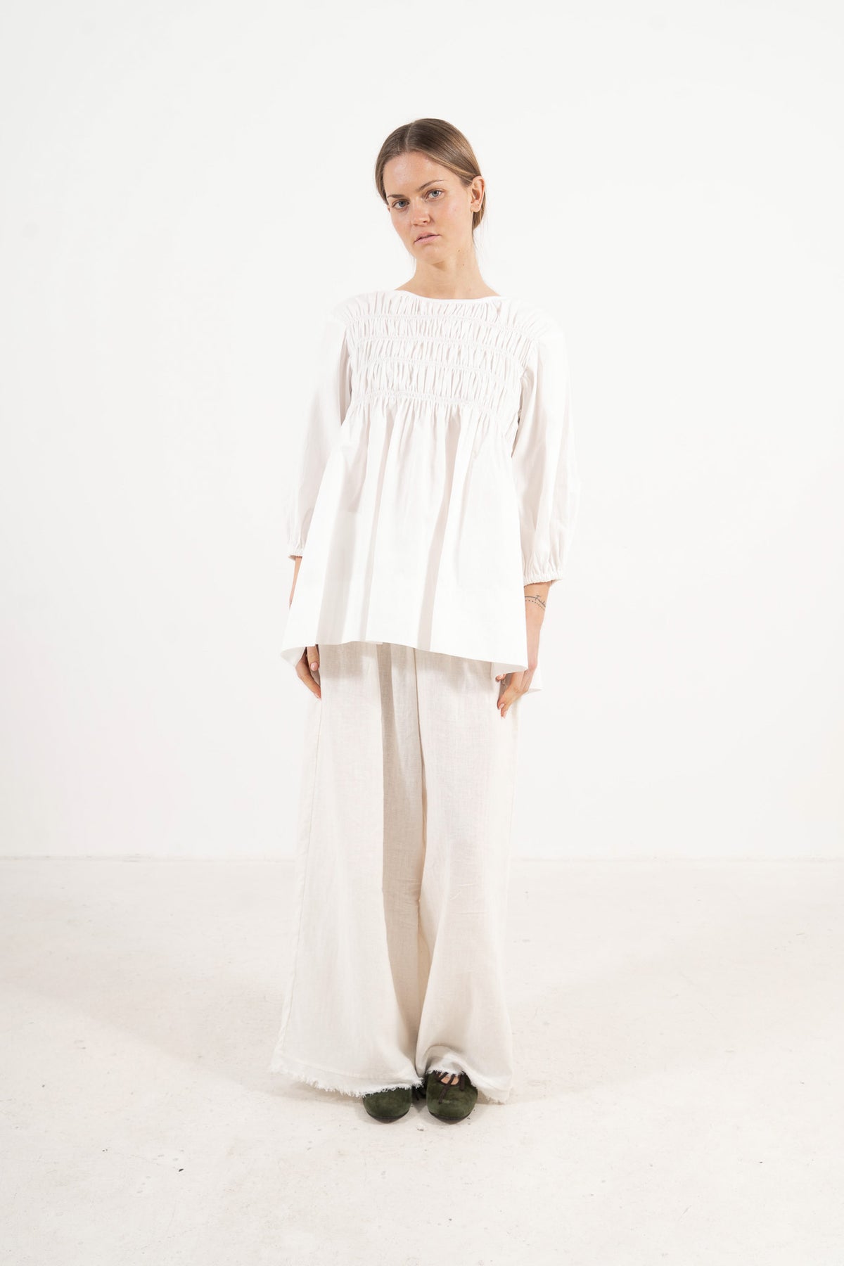 Front view studio portrait featuring a model in the La Cour Blouse by MOCHA, capturing its aristocratic grace, soft drape, and understated opulence.