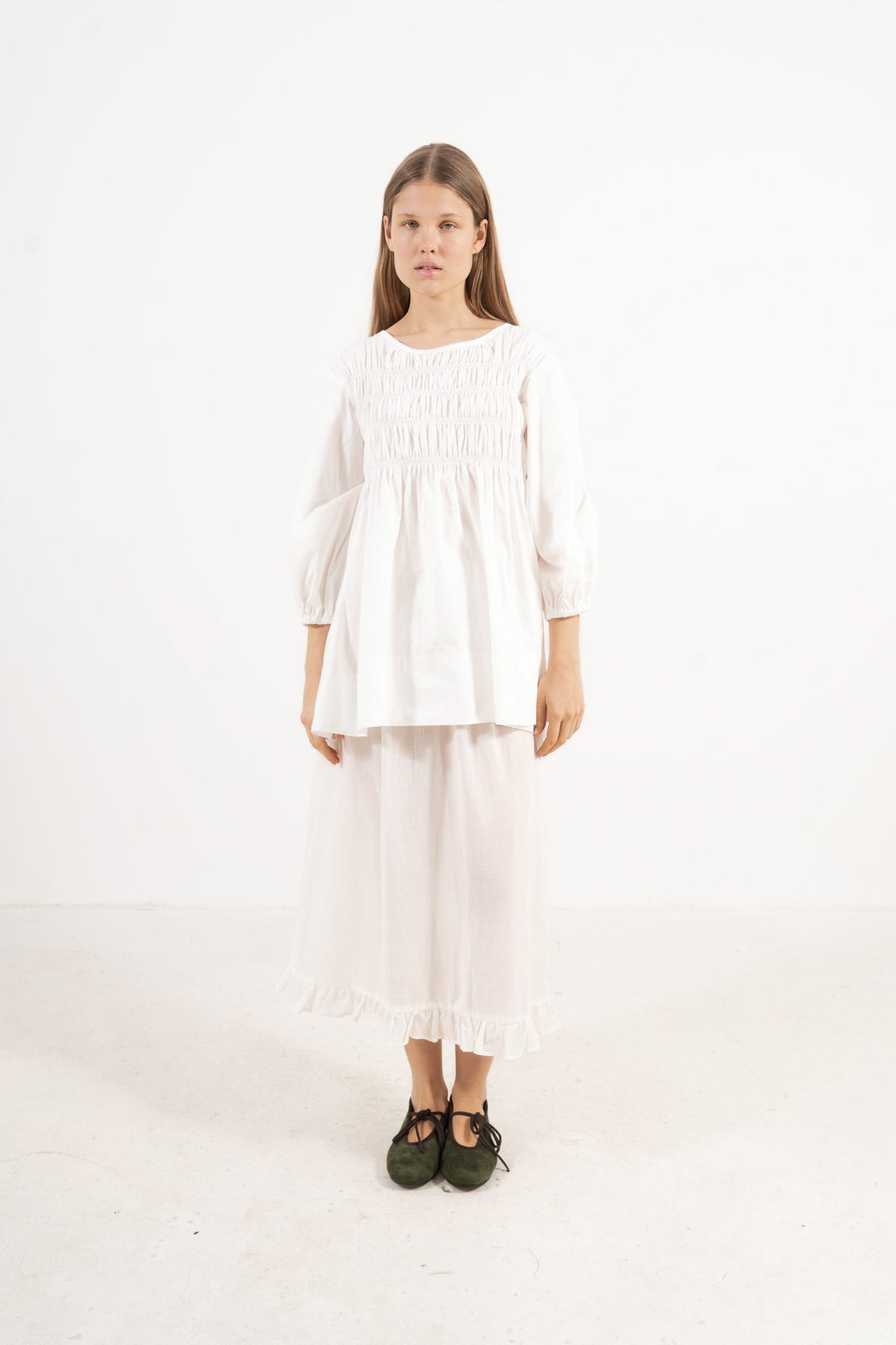 Front view studio portrait featuring a model in the La Cour Blouse by MOCHA, capturing its aristocratic grace, soft drape, and understated opulence.