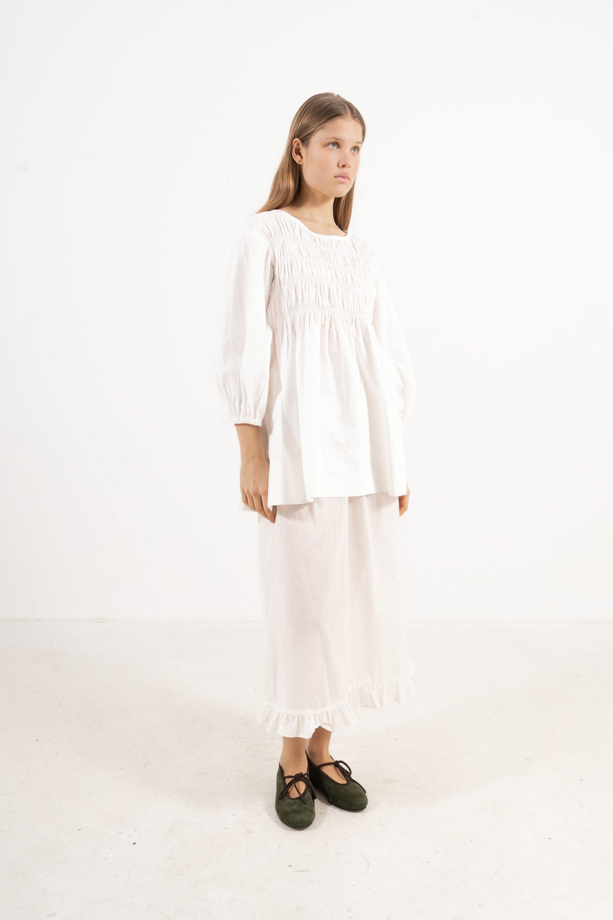 Profile studio portrait showcasing the refined structure, clean lines, and commanding presence of the MOCHA La Cour blouse.