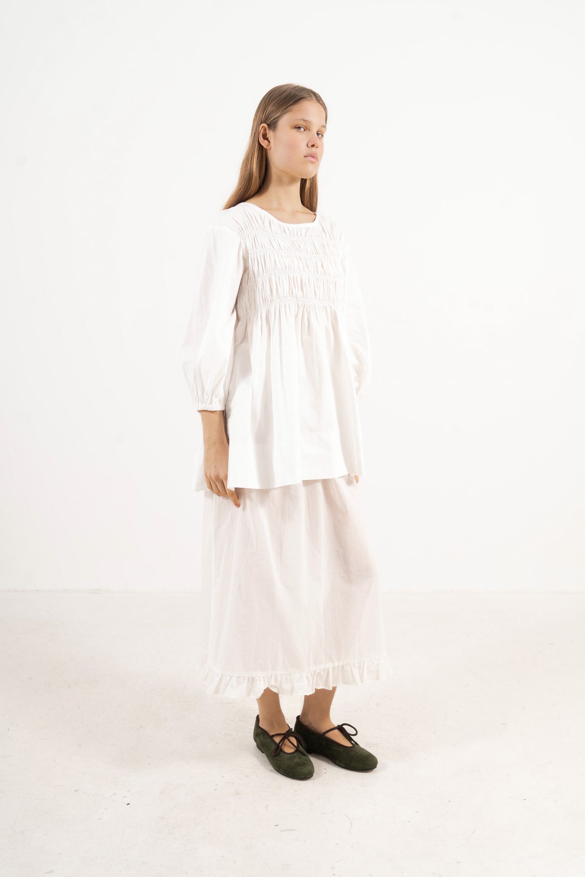 Side lookbook capture of the premium cotton blouse, emphasizing the beautiful, fluid movement of the sleeves inspired by the timeless grandeur of the French court.