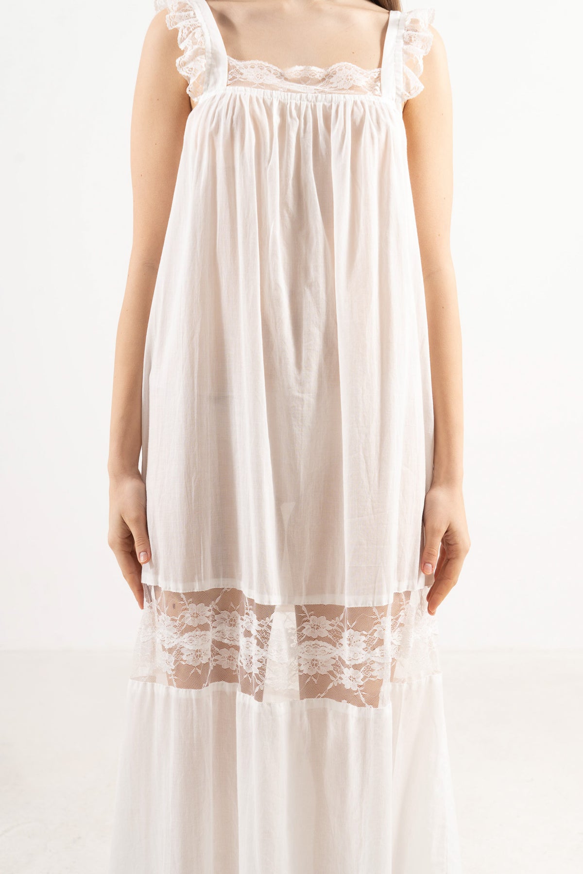 Close-up detail shot focusing on the delicate flower details and the exceptionally fine, airy texture of the pure MOCHA cotton weave