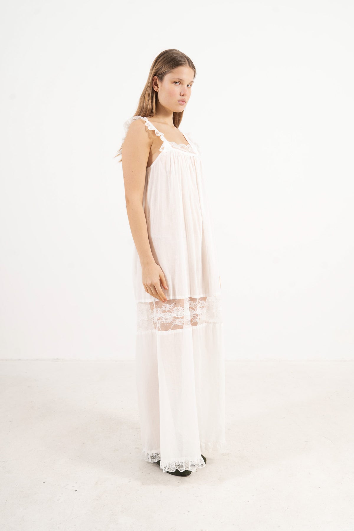 Side lookbook capture of the premium cotton dress, emphasizing how the weightless, breathable fabric drapes beautifully and effortlessly.