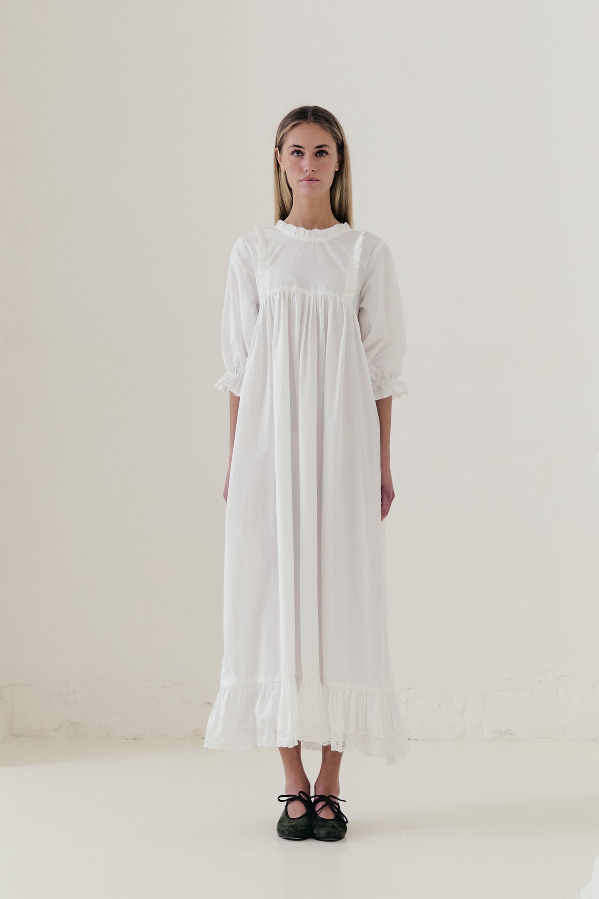 Front view studio portrait featuring a model in La Robe Noblesse by MOCHA, embodying aristocratic grace and understated opulence.