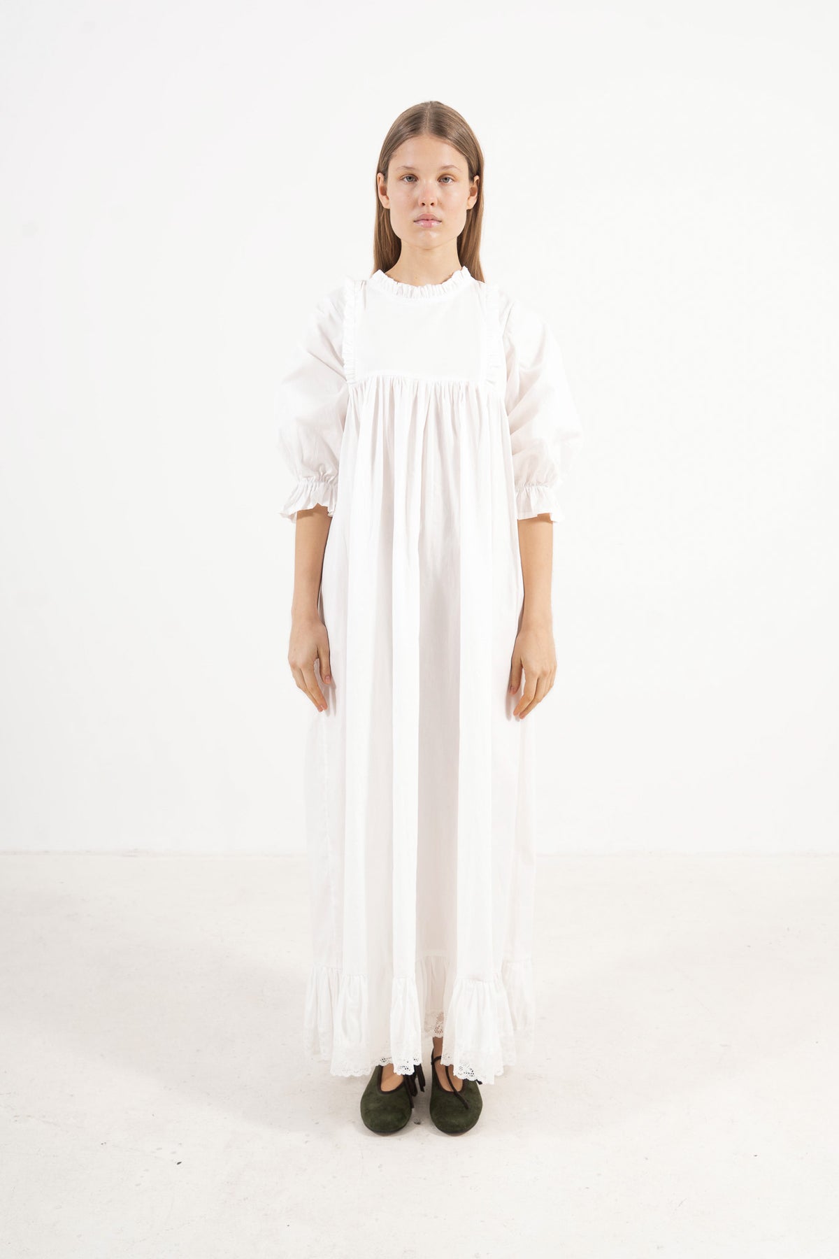 Front view studio portrait featuring a model in La Robe Noblesse by MOCHA, embodying aristocratic grace and understated opulence.