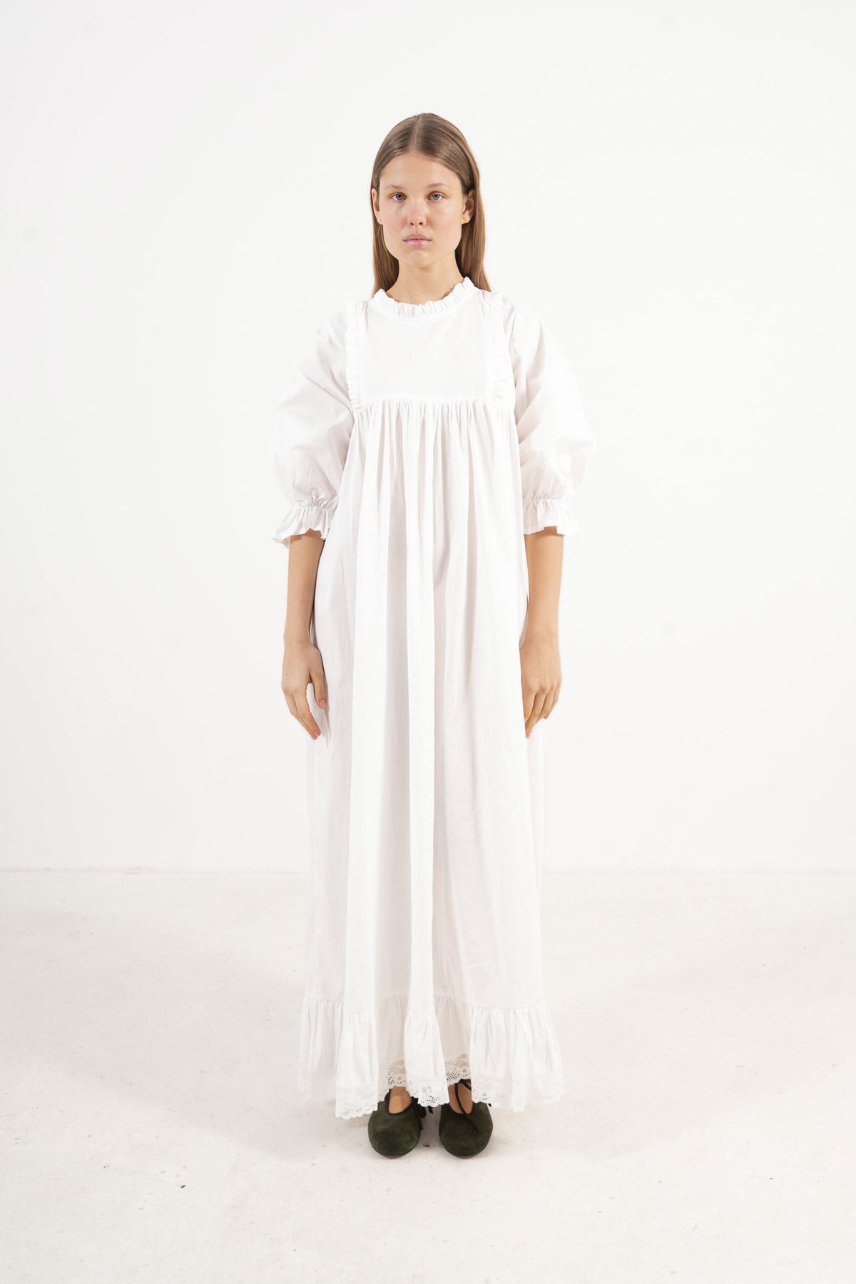 Front view studio portrait featuring a model in La Robe Noblesse by MOCHA, embodying aristocratic grace and understated opulence.