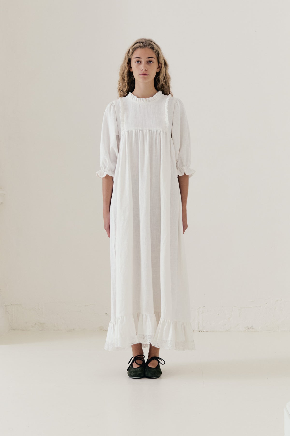 Front view of the MOCHA La Robe Noblesse long dress featuring ruffled sleeves and a clean silhouette against a white studio background.