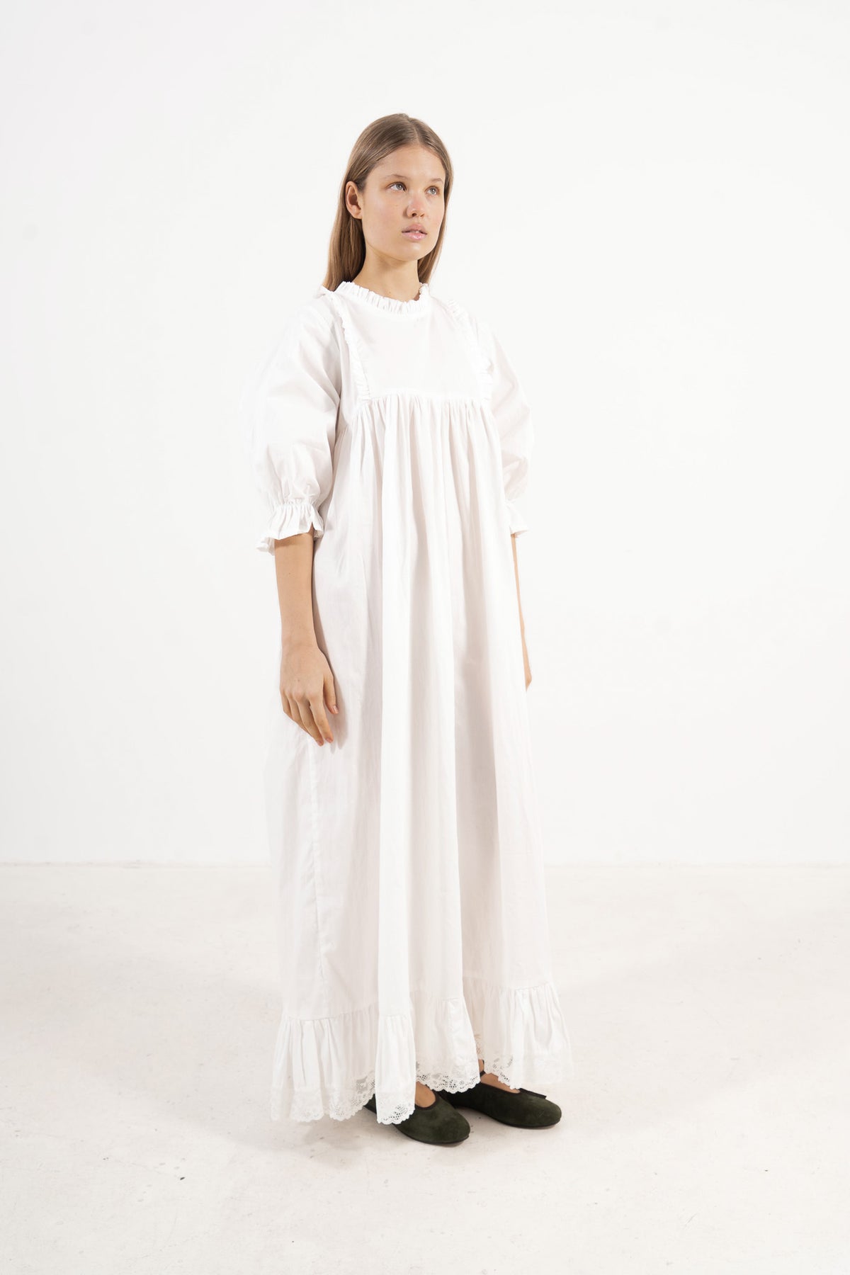 Profile studio portrait showcasing the refined structure, clean lines, and commanding presence of the MOCHA Noblesse dress.