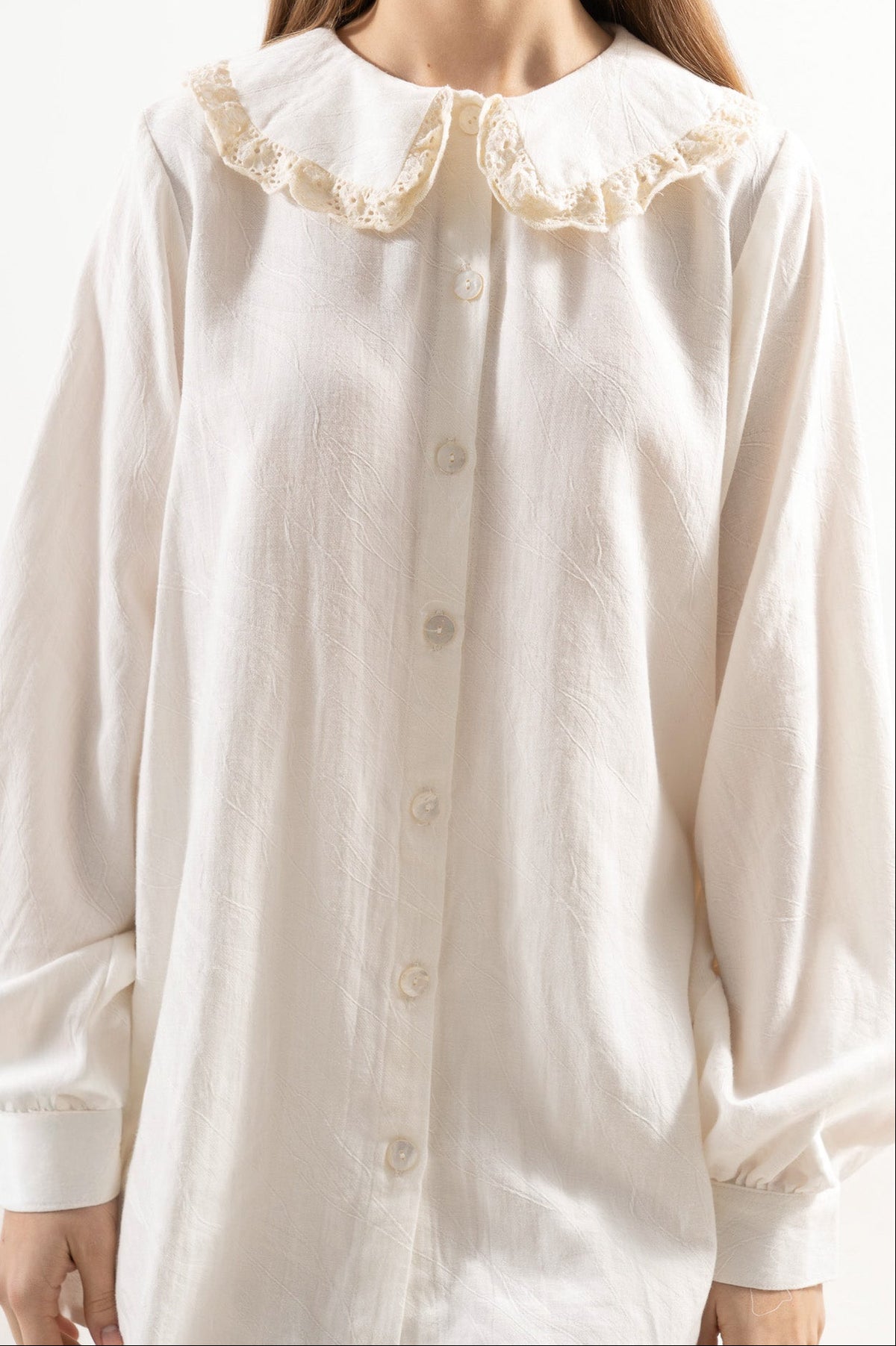 Close-up detail shot focusing on the delicate collar details, fine textures, and premium craftsmanship of the MOCHA cotton blouse.