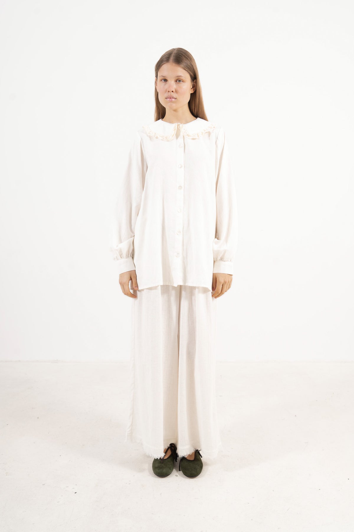  Front view studio portrait featuring a model in the Le Souffle Blouse by MOCHA, wrapping you in effortless elegance and gentle lightness.3. Side shot