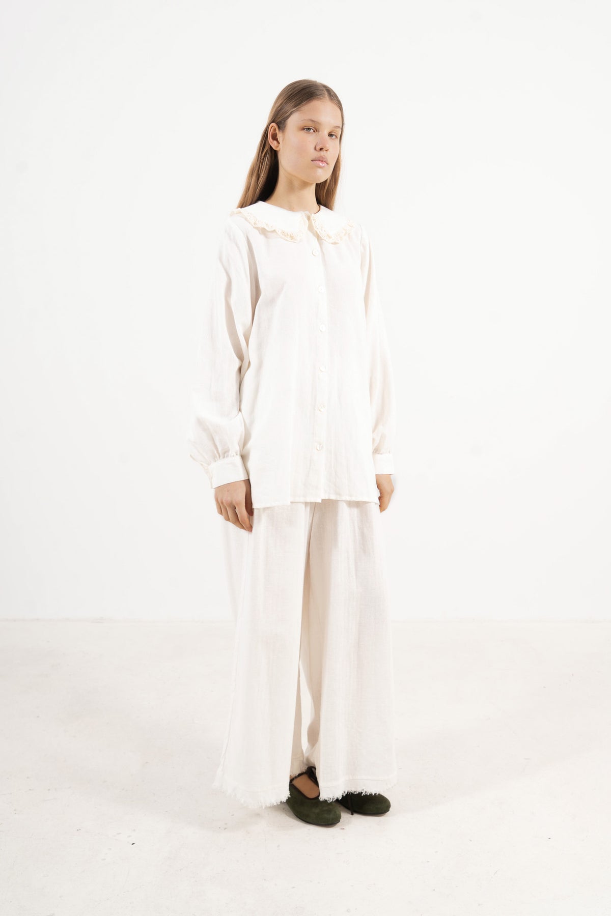 Side lookbook capture of the cotton blouse, emphasizing how the long sleeves and light fabric move with effortless grace.