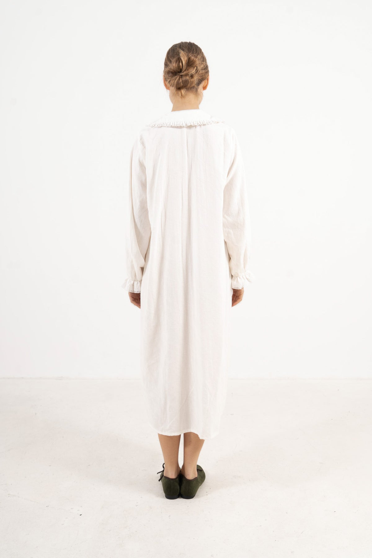 Minimalist back silhouette view of the long dress, capturing the sense of ease and timeless, clean design.