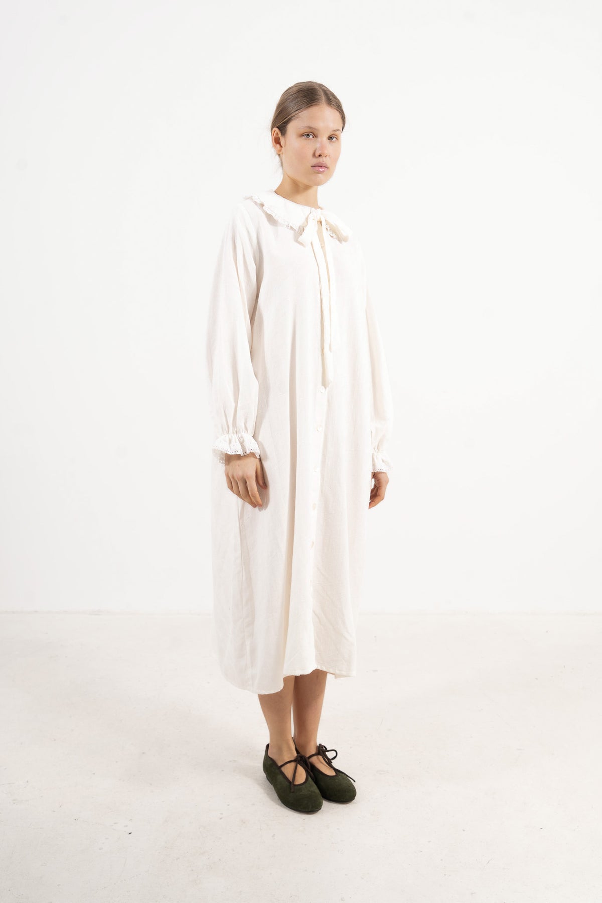 Studio lookbook capture highlighting the relaxed fit, pure structure, and graceful long sleeves of the MOCHA Le Souffle dress.
