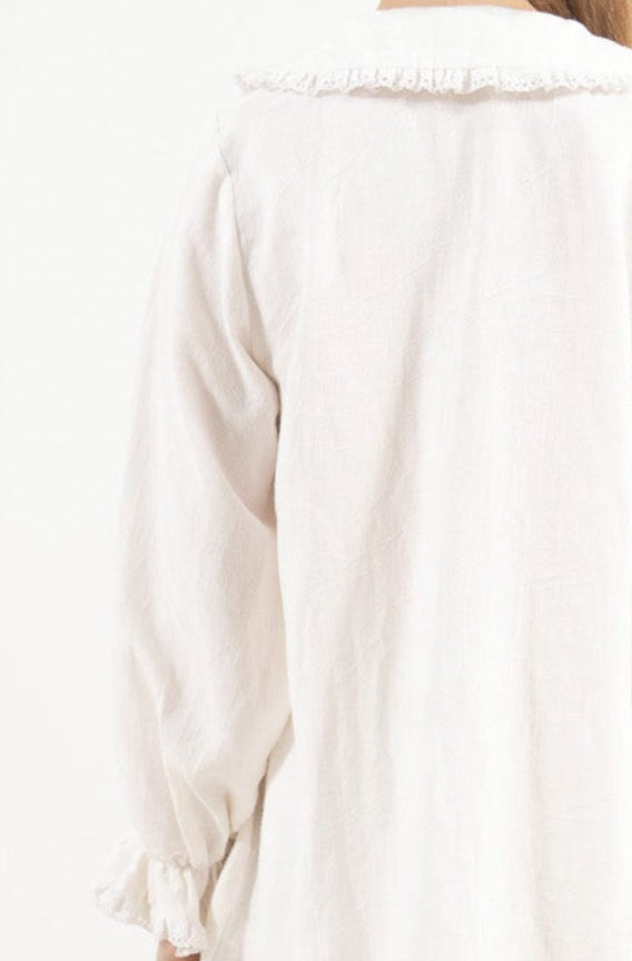 Back view of the timeless cotton tunic on a model, capturing the gentle aesthetic and quiet elegance of the piece.