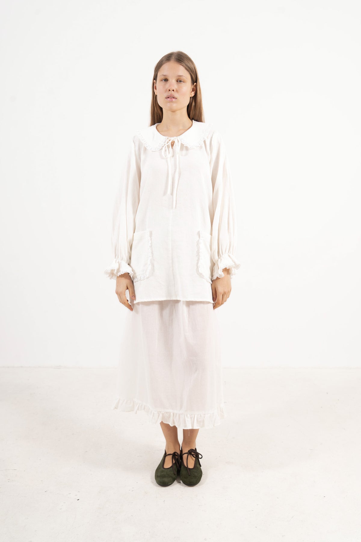 Front view studio portrait featuring a model in the Le Souffle tunique by MOCHA, wrapping you in effortless elegance and gentle lightness.