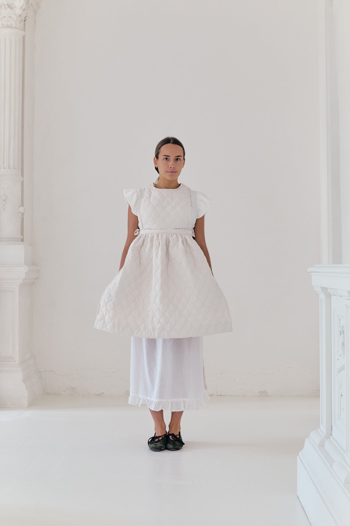 Le Tablier de Poésie Mid Apron from the POÈME line by MOCHA, highlighting the clean front silhouette and delicate volants in a studio lookbook view.