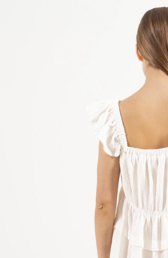 Back silhouette of the sustainable Chloe Dress, showcasing the relaxed drape and elegant fluid motion.