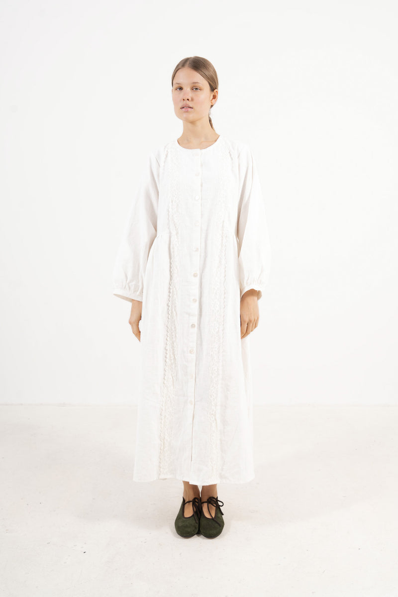 The Madeleine Dress from the POÈME La Clémence collection by MOCHA, showcasing an understated presence and gentle structure in a front view.