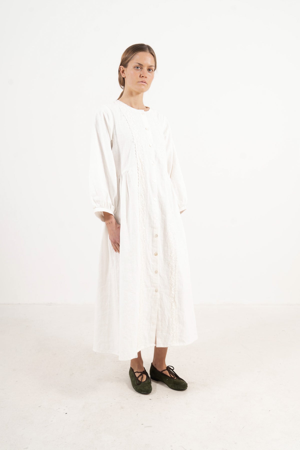 The Madeleine Dress from the POÈME La Clémence collection by MOCHA, showcasing an understated presence and gentle structure in a front view.