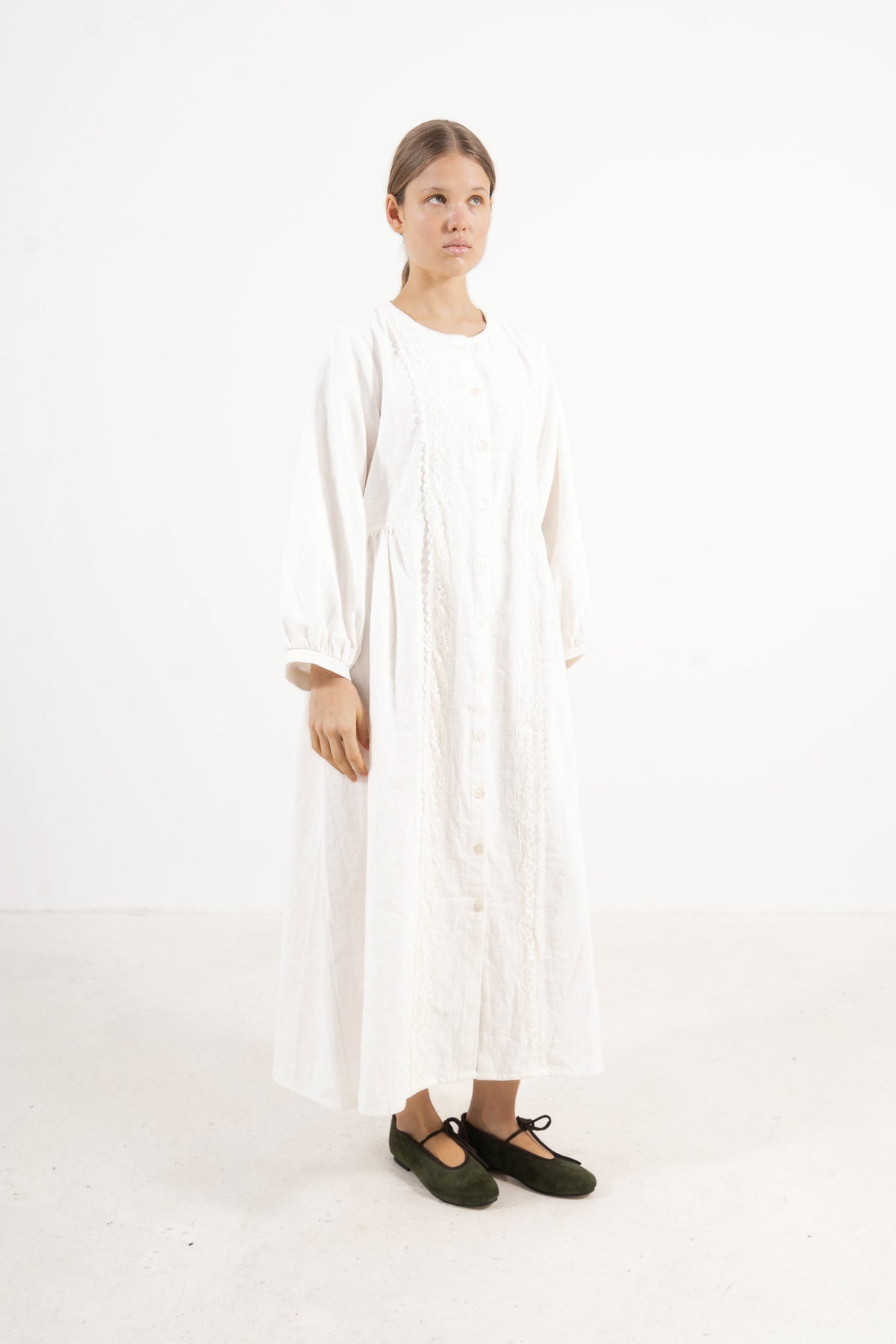 Editorial lookbook capture of the Madeleine Dress, embodying a study of softened elegance and quiet luxury.