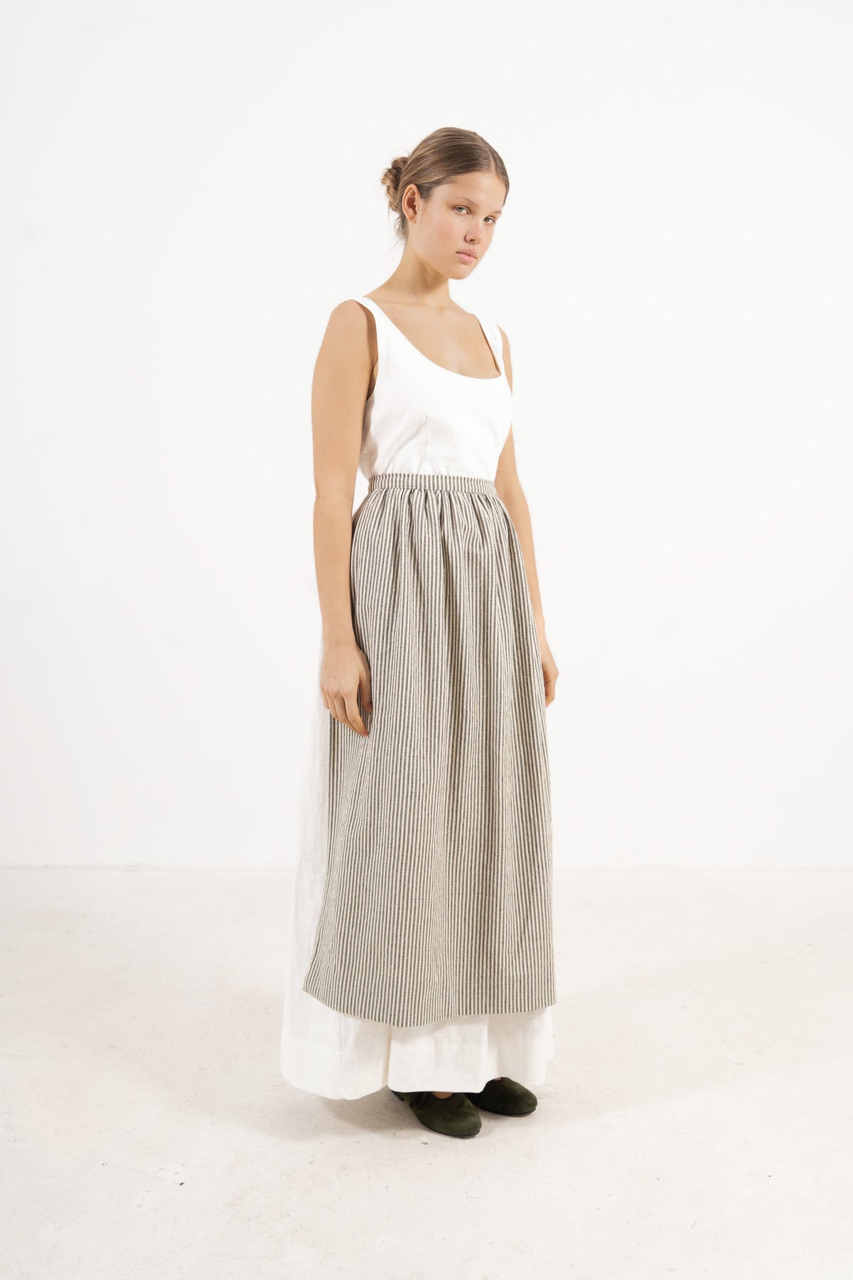 Le Tablier Striped Apron from the POÈME La Cuisine line by MOCHA, highlighting the clean silhouette and timeless woven stripe pattern in a front lookbook view.
