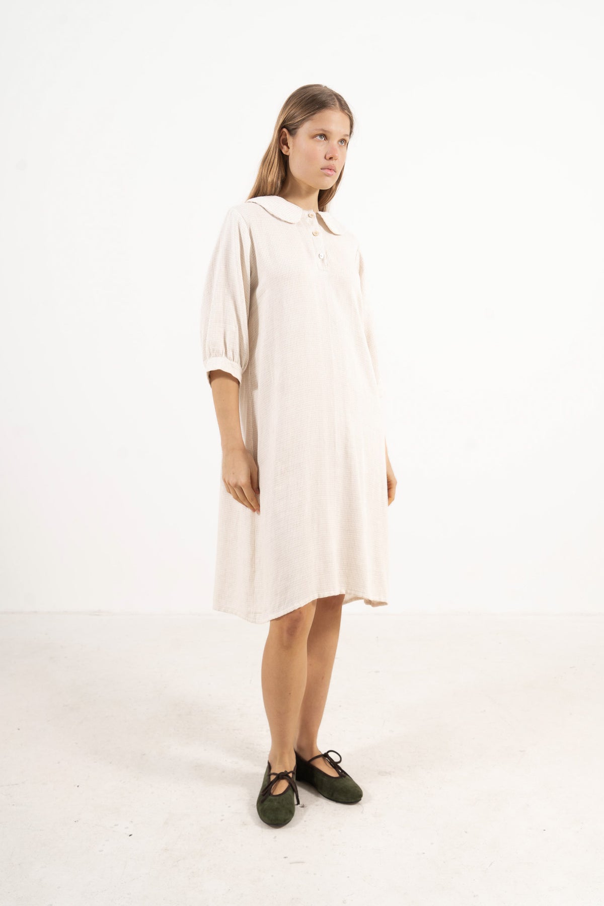 Side profile view of the Mielle Sleeve Dress, capturing the soft movement, sleeve structure, and understated femininity signature to MOCHA.