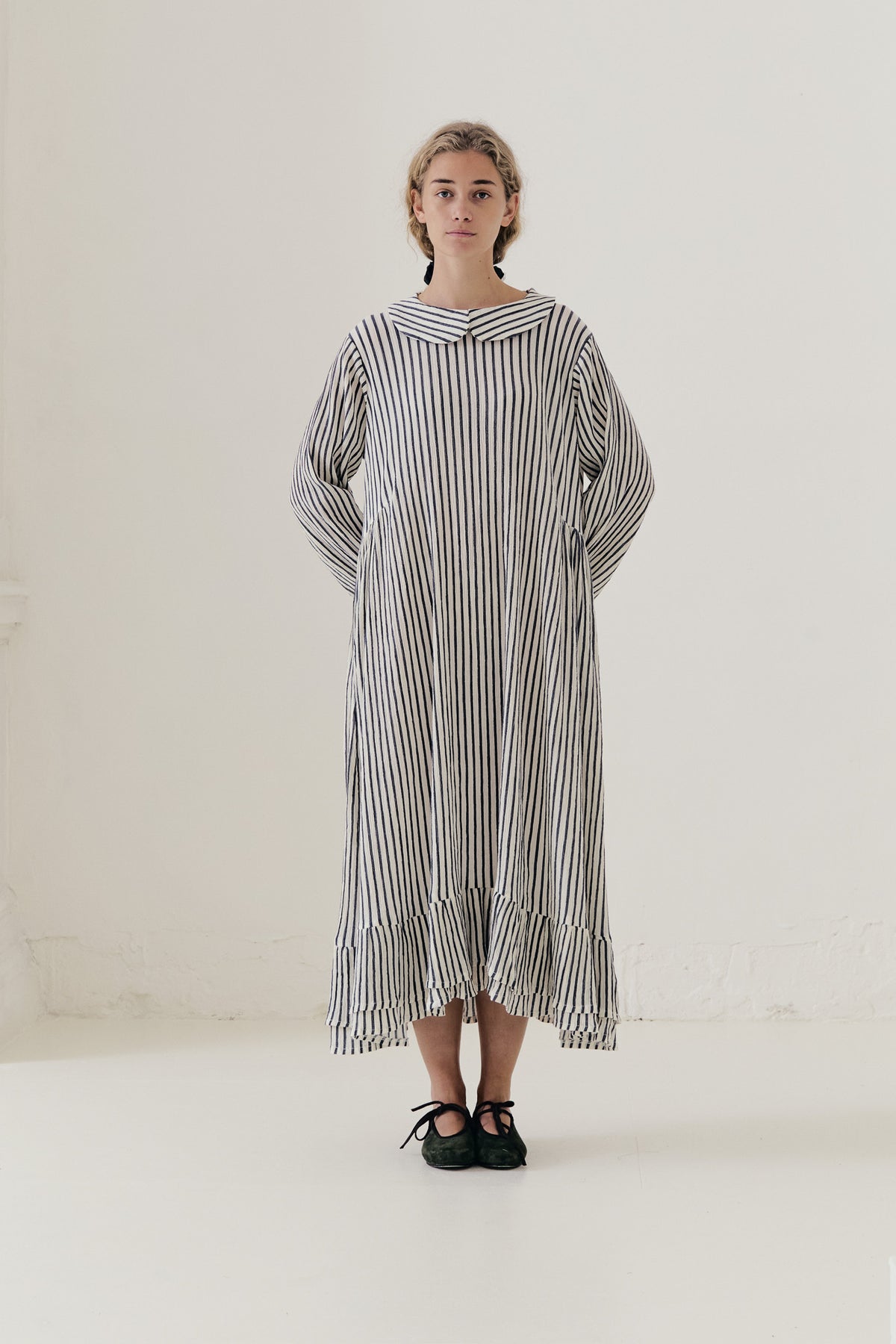 Bright, sunlit editorial lookbook capture of the striped Sillage dress, floating gracefully with an effortless sense of lightness.